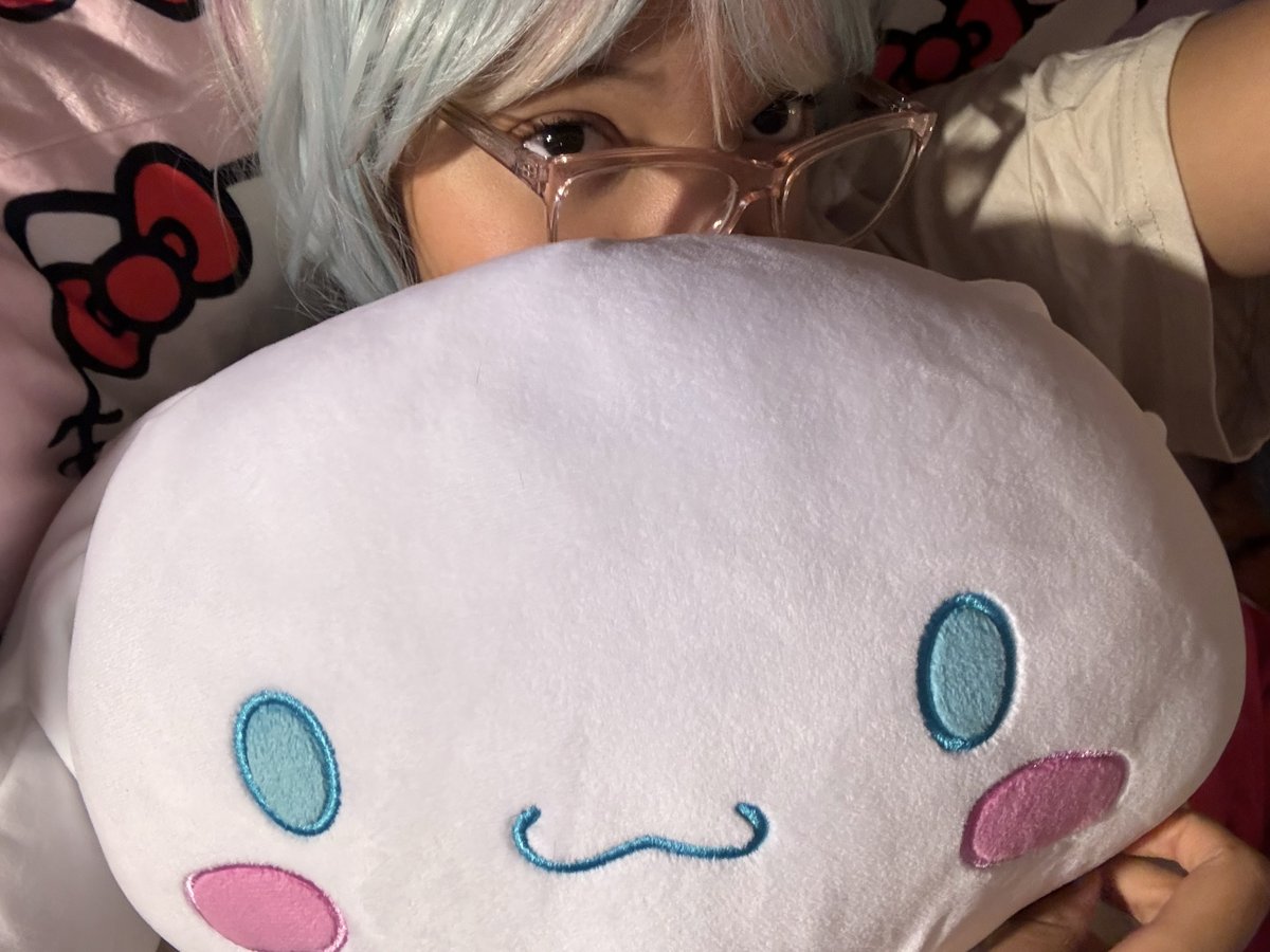 mya peeking over a Cinnamoroll plush with ice blue hair and glasses